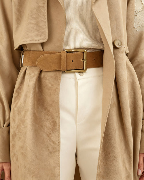 the anchor — the camel suede belt cinching an oversized coat at the waist