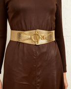 the scale: the wide gold scale belt at the waist of a chocolate leather dress