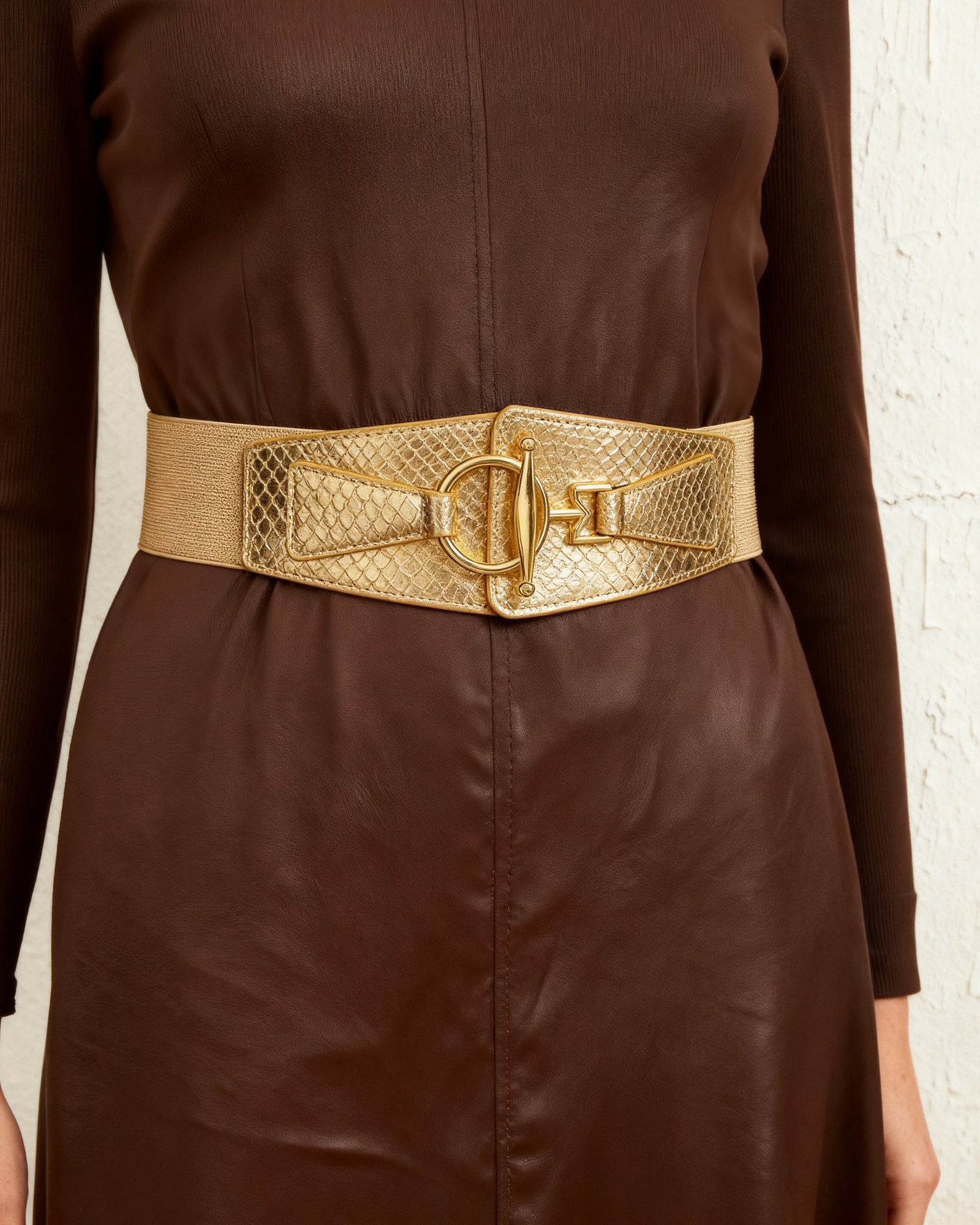 the scale: the wide gold scale belt at the waist of a chocolate leather dress
